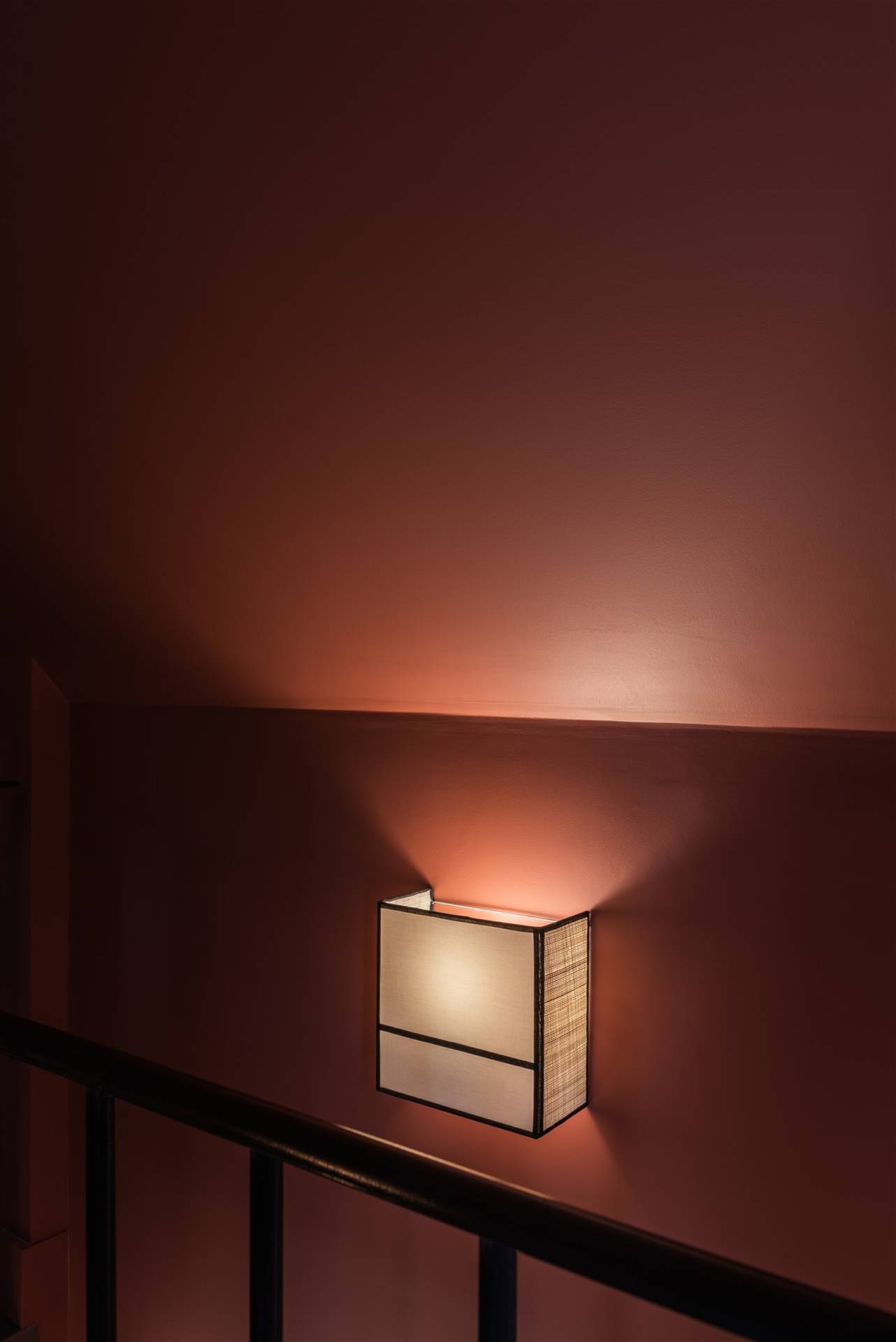 Vue cage escalier avec murs terracotta et applique rabane et ganse noir, par Virginie Vaudenay, Décoratrice UFDI à Sancerre, dans le Cher (18), la Nièvre (58) , le Loiret (45) et L’Yonne (89), et Sologne(41)